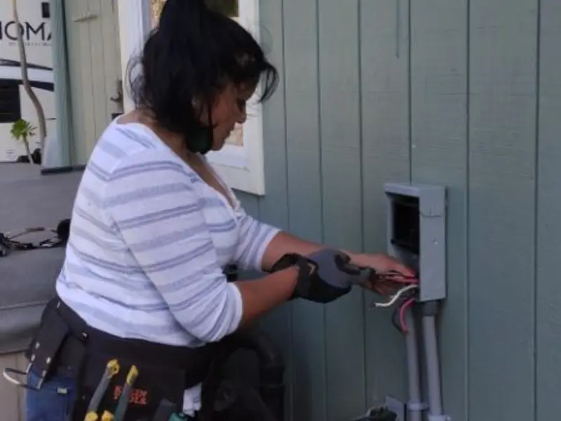 Licensed electrician wiring an exterior subpanel in Marion